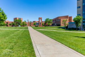 A sidewalk on Wright State University which leads visitors to the red brick alumni tower