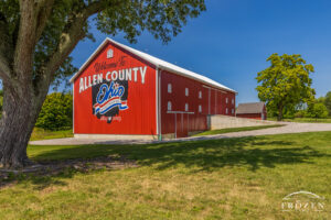 A bright red, renovated barn featuring aluminum siding serves as the Allen County Ohio Bicentennial Barn