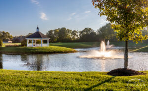 A morning view from Centerville, Ohio's Grace Park where golden light paints the gazebo and park in golden light as the fountain spray dances in the sunlight