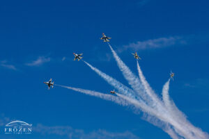 A USAF Thunderbird art print featuring their Delta Burst maneuver at the Columbus Air Show where the contrails highlight how their tight formation rapidly diverges under blue Ohio skies.