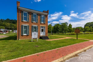 A fine art print of a two-story red-brick home that belonged to abolitionist John P. Parker of Ripley, Ohio