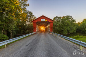 A classic Ohio covered bridge where its east-west alignment allowed the setting sun to illuminate the roadway as it passes through the bridge.