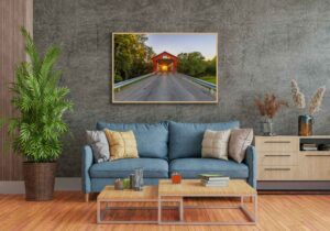 An AI room visualization featuring my fine art print of the McColly Covered Bridge where I caught the setting sun shining through the bridge.