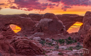 A view of the Arches National Park North and South Windows which form a pair of spectacles during a colorful Moab sunrise