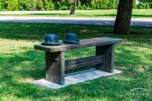 A brozne sculpture of two hats on a bench that pays tribute to the Wright Brothers located on Wright Patterson AFB