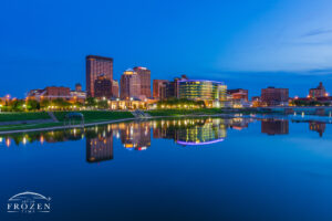 Dayton Skyline where the Miami River perfectly reflects the warm city lights which complements the deep blues of twilight