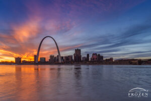 The St Louis Skyline from across the Mississippi River during a colorful twilight where the upper level clouds refracted light in their own manner for an impressive scene.