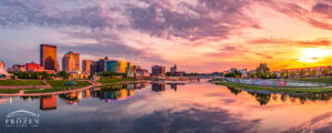 Dayton Skyline panorama during a colorful sunset where the -smooth Great Miami River perfectly mimics the entire spectacle