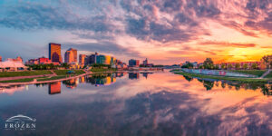 Dayton Skyline panorama during a colorful sunset where the smooth Great Miami River perfectly mimics the entire spectacle