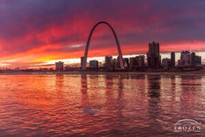 A fiery sunset over St Louis Missouri as captured across the Mississippi River which carries ice flows and reflects the St Louis skyline