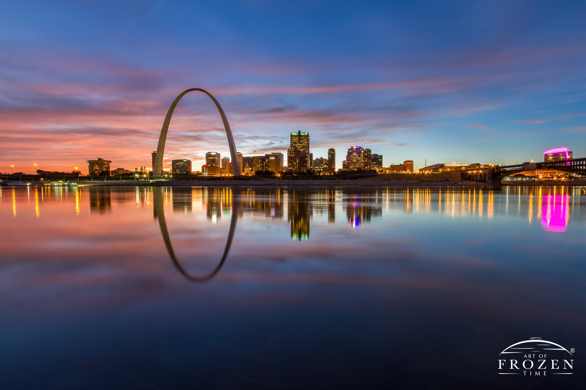 Twilight over St Louis Missouri where the smooth Mississippi River perfectly reflected the St Louis skyline and Gateway Arch