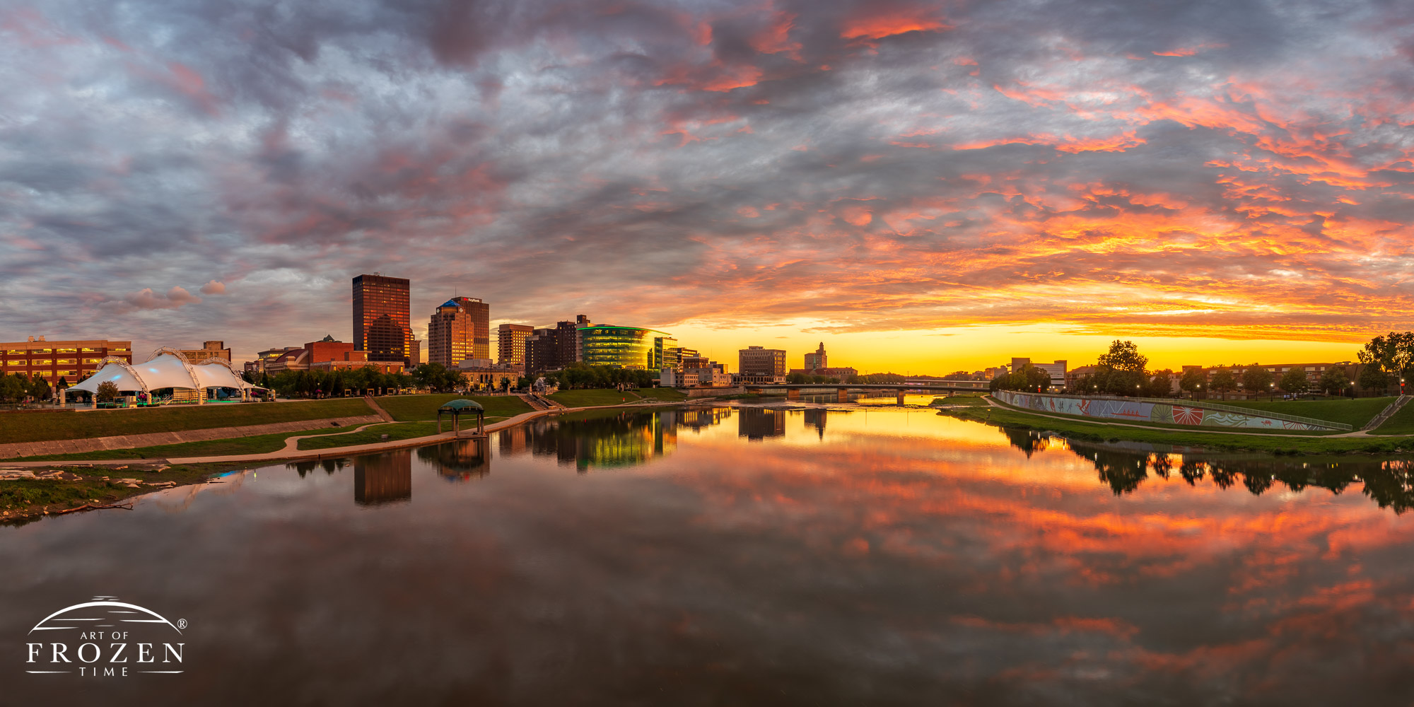 Dayton Skyline panorama at sunset as the Miami River reflects the colorful and fiery clouds over the Miami Valley