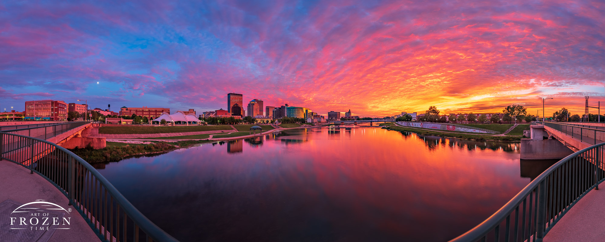 Panorama of the Dayton Skyline where the heavily clouded sky caught warm colorful light appearing as skyfire