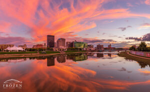 A Dayton Skyline panorama where orange cirrus clouds gently arch over the Miami Valley, while the Miami River reflects the cityscape