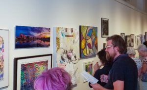 An exhibit attendee examining one of my Dayton Skyline prints at The Dayton Contempoary