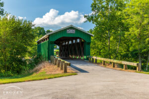 Restored covered bridge sports green paint and new roof as it spans Caesar Creek on this mid-summer evening