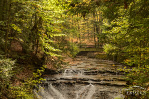 An intimate view of Bridal Veil Falls where the stream bed begins filling with autumn leaves as sunlight illuminates the hemlock