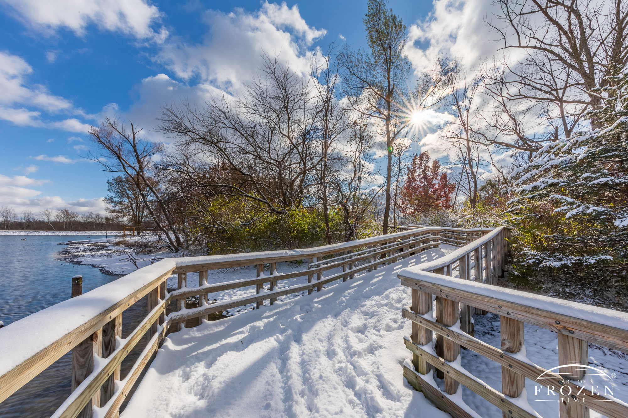 A snow covered walkway at Carriage Hill MetroPark sparkles as the sunlight refracts from fresh snow