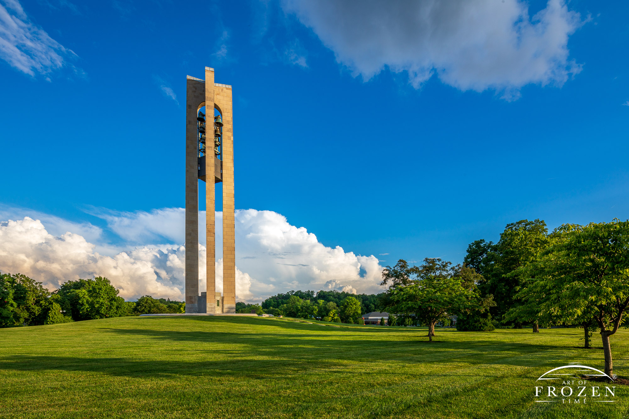 Deeds Carillon takes on warmer colors in this golden hour view of Dayton's Bell Tower as distant storms linger on the horizon