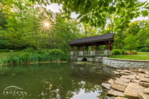 Dogwood Pavilion at Hills and Dales MetroPark at sunrise where trees filter the golden morning sunlight over Dogwood Pond