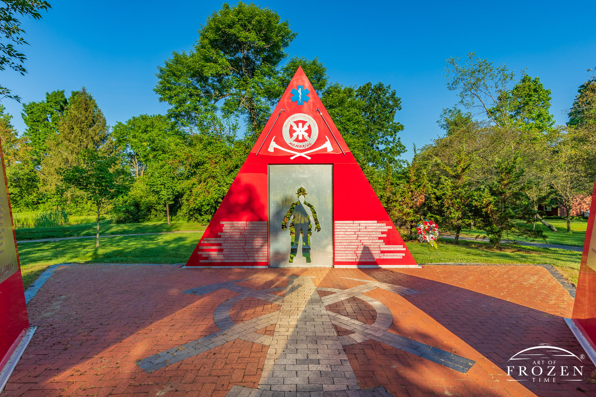 A sculpture honoring Miami Valley Firefighters called Firewall lies in Stubbs Park, Centerville Ohio basks in the golden morning light