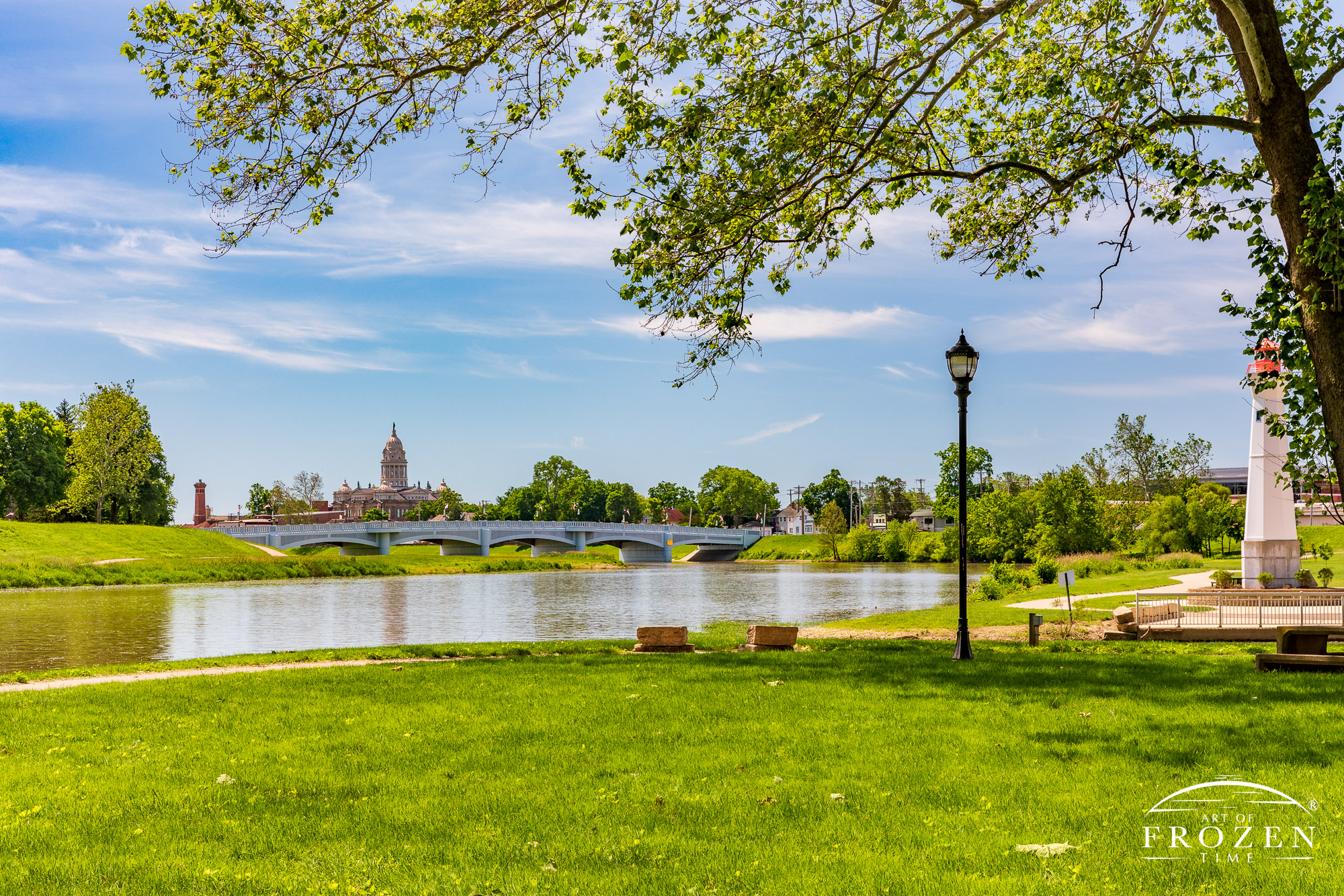 A summer scene in Troy Ohio from Treasure Island as the Great Miami River flows under sunny blue skies