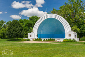 A pretty June day where the blue and white Band Shell at Island MetroPark competes with the blue skies and white puffy clouds hanging over Dayton Ohio