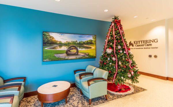 A large canvas print of a rock sculpture at sunrise in the waiting room of the Kettering Health Network Cancer Center