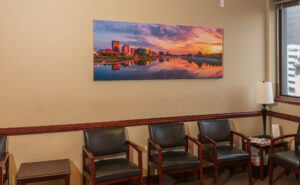 A six-foot wide canvas print in the waiting room depicting a colorful sunset over the Dayton Ohio skyline