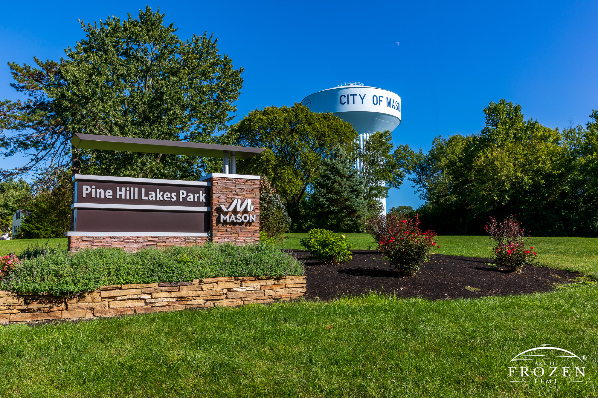 The park entrance sign for Pine Hills Lakes Park on a pretty day with blue skies