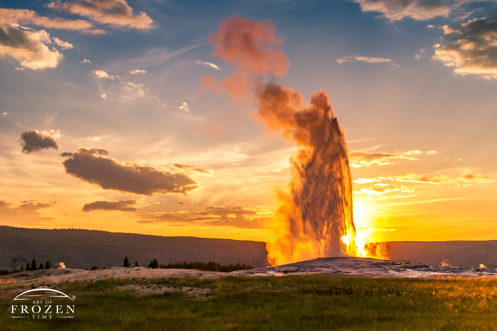 As Old Faithful geyser erupted the setting sun backlit the geothermal spray revealing a pareidolia in the form of a robed-figure with hands pressed into a praying position