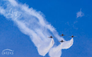 The US Air Force Aerial Demonstration Team Thunderbirds in diamond formation against a blue azure skies