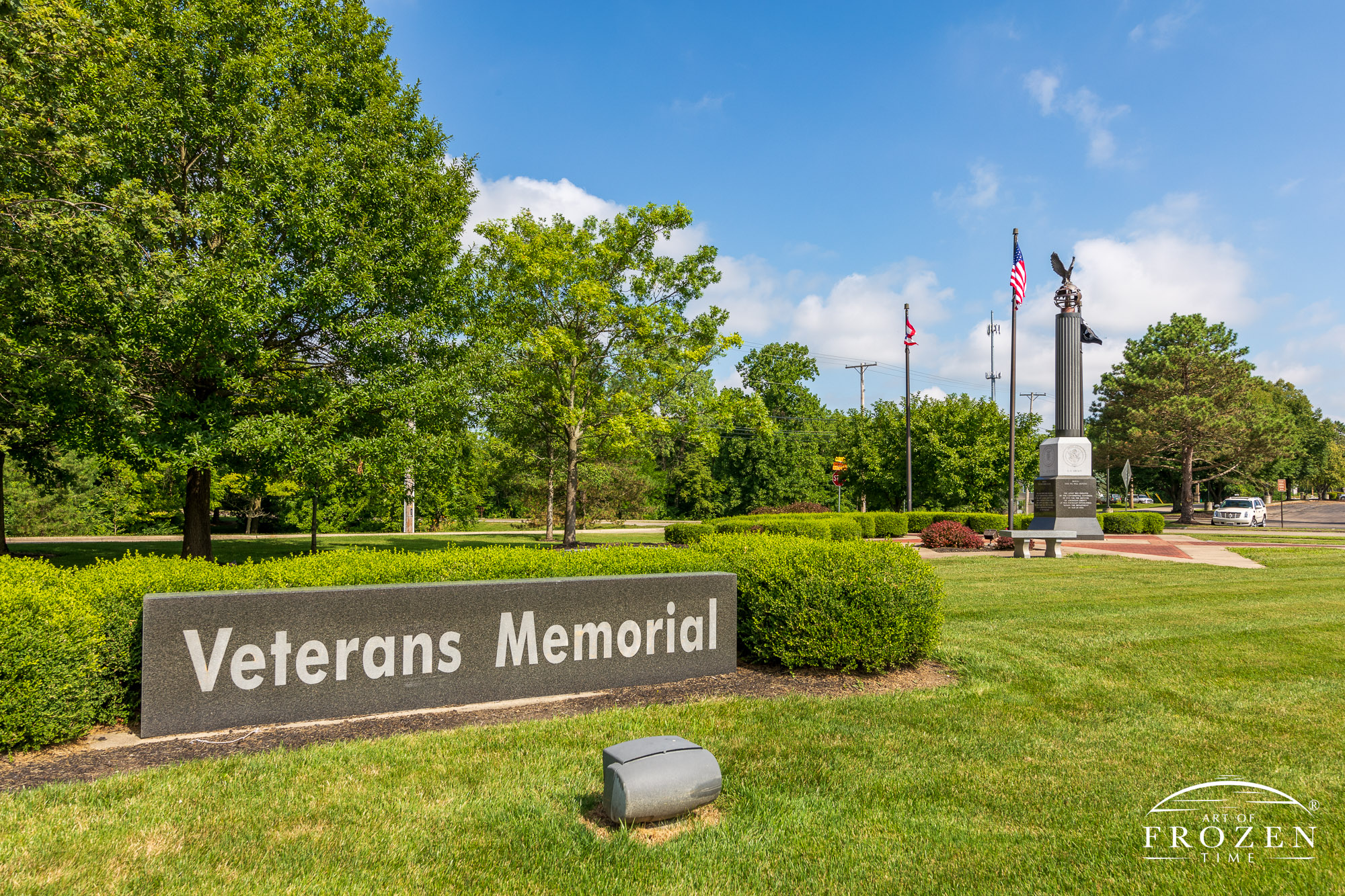 The Beavercreek Veterans Memorial on a sunny day with puffy clouds which honors local veterans from each of the five services