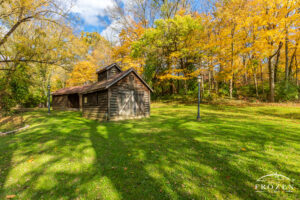 A Bellbrook Ohio wood shed surrounded by sugar maple trees displaying their bright yellow leaves