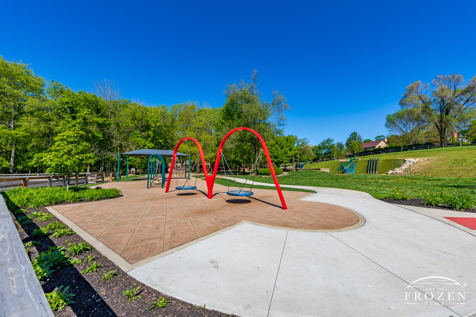 Owen’s Place is a universally accessible playground surrounded by trees and blue skies