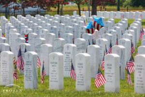An intimate view of the white headstones in Dayton National Cemetery decorated by boy scouts and family members for Memorial Day