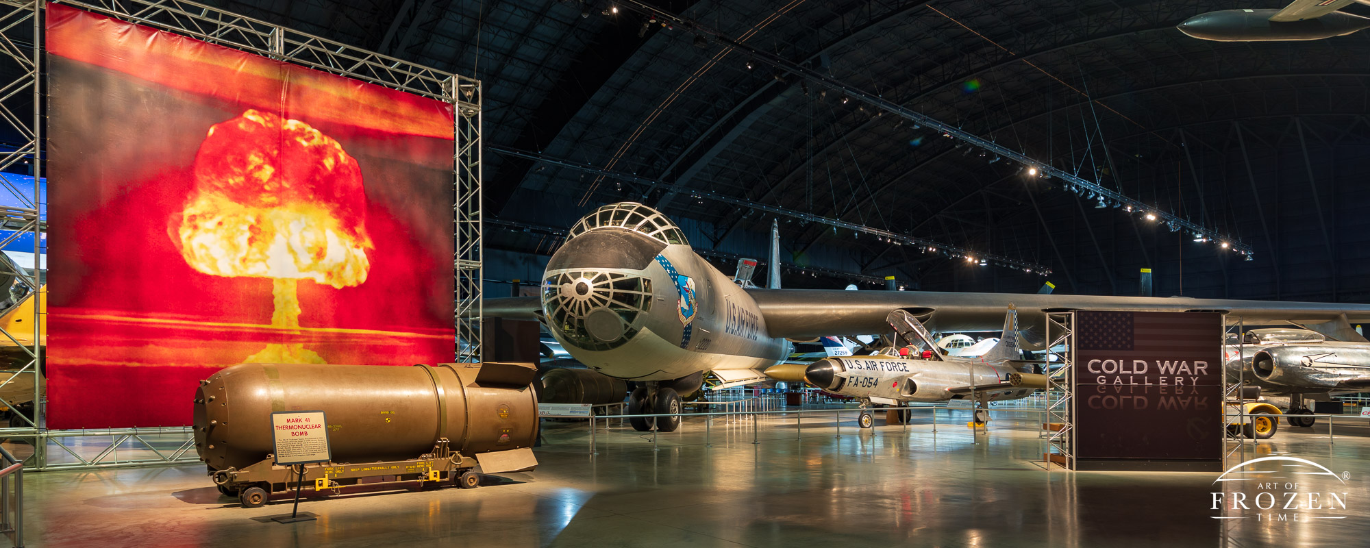 The front view of the B-36 Bomber and its multi window cockpit as it sits under museum lights at the National Museum of the US Air Force
