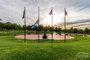 Evening view of Centerville’s Veterans Memorial where the city of Centerville flag flies at half staff as a veil of clouds filter the golden light
