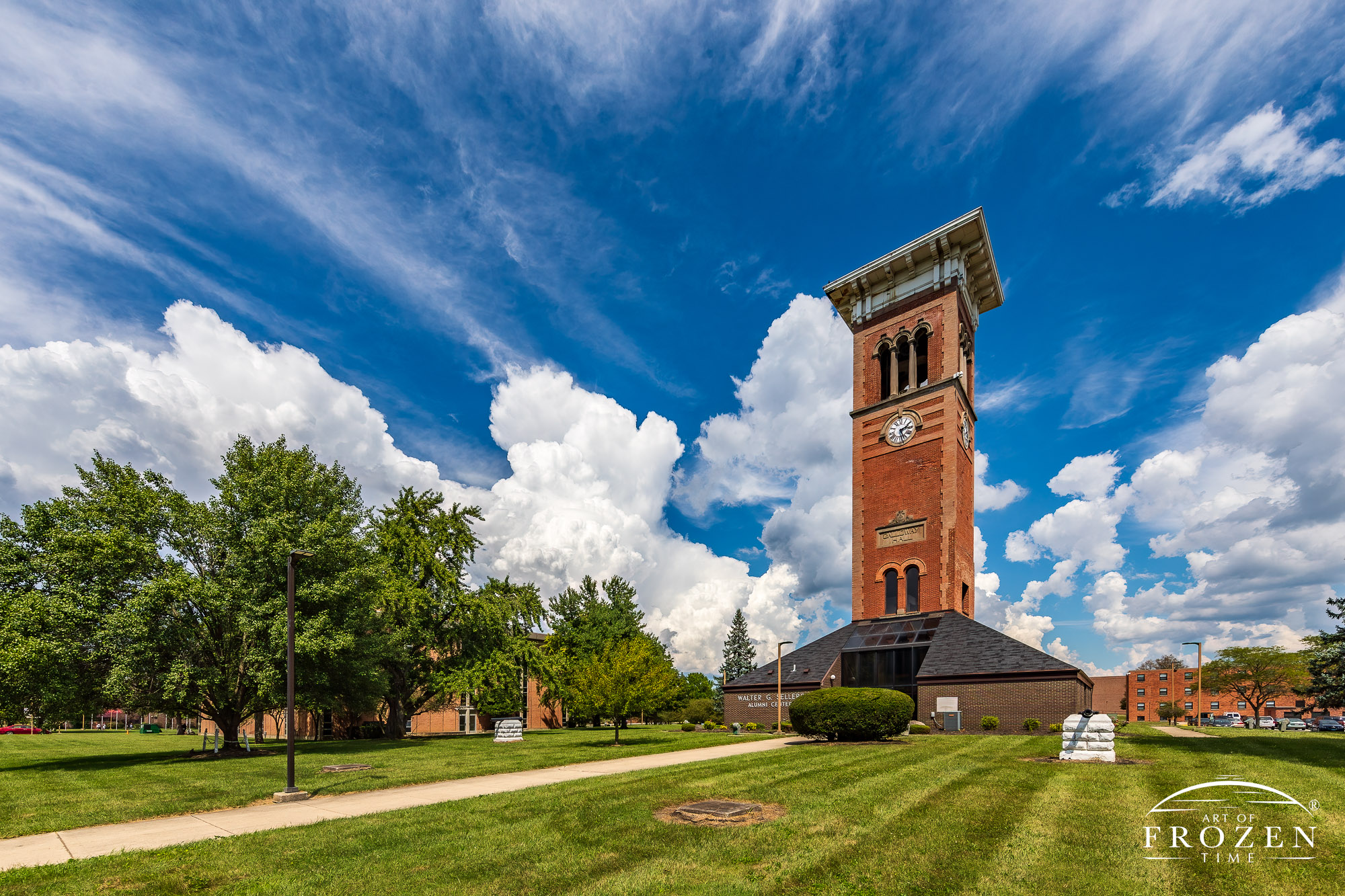 The Central State University Alumni Center towers among the cumulonimbus clouds on a summer day