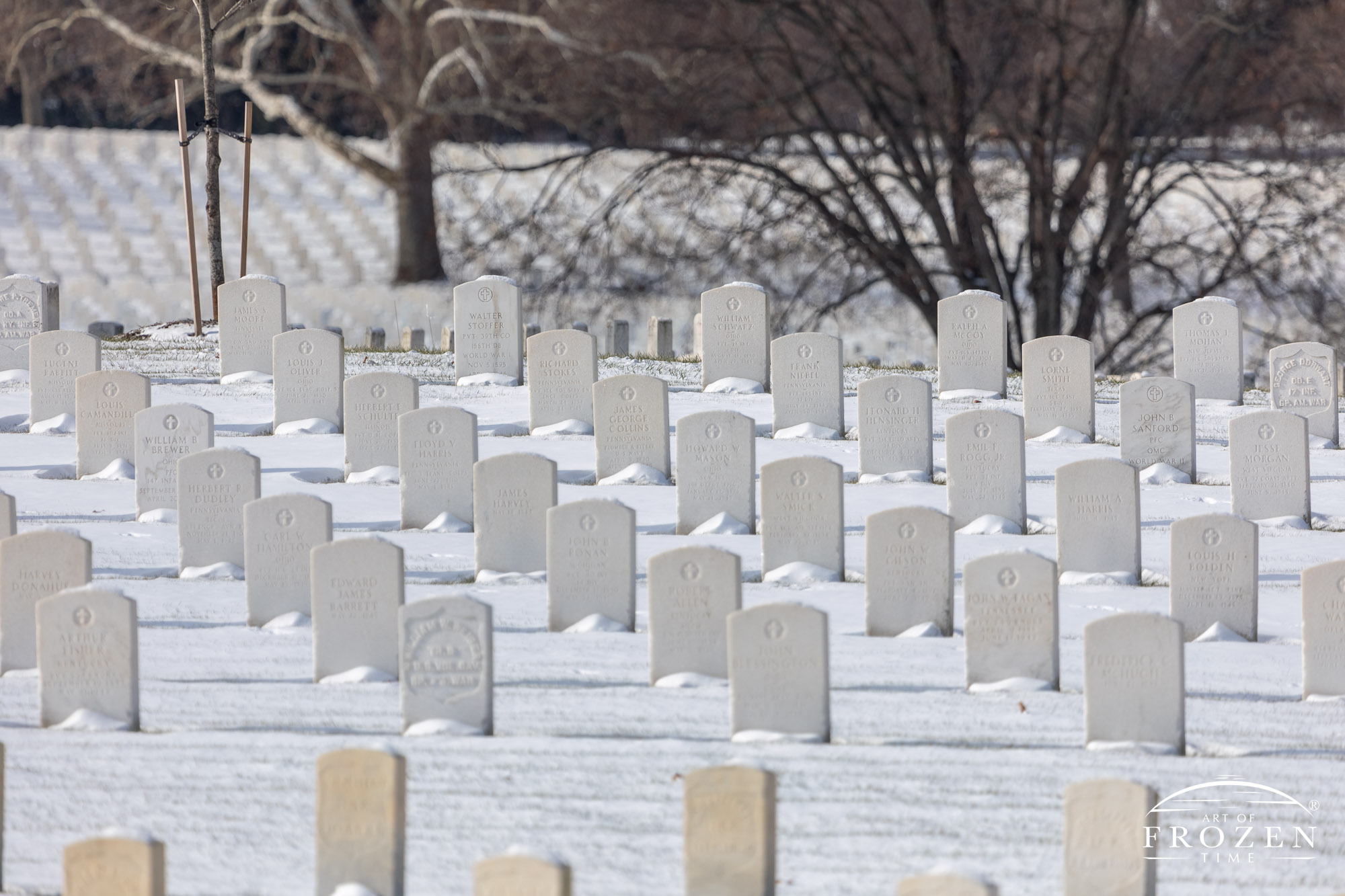 A distant snow covered hill at Dayton National Cemetery where the white orderly headstones have stood for over 150 Christmas seasons