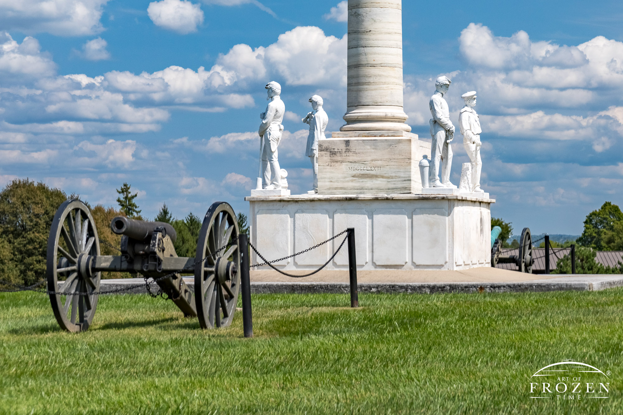 A close view of the center monument of Dayton National Cemetery where the white marble Civil War era soldiers watch over the acres of Veteran headstones that stretches on for acres