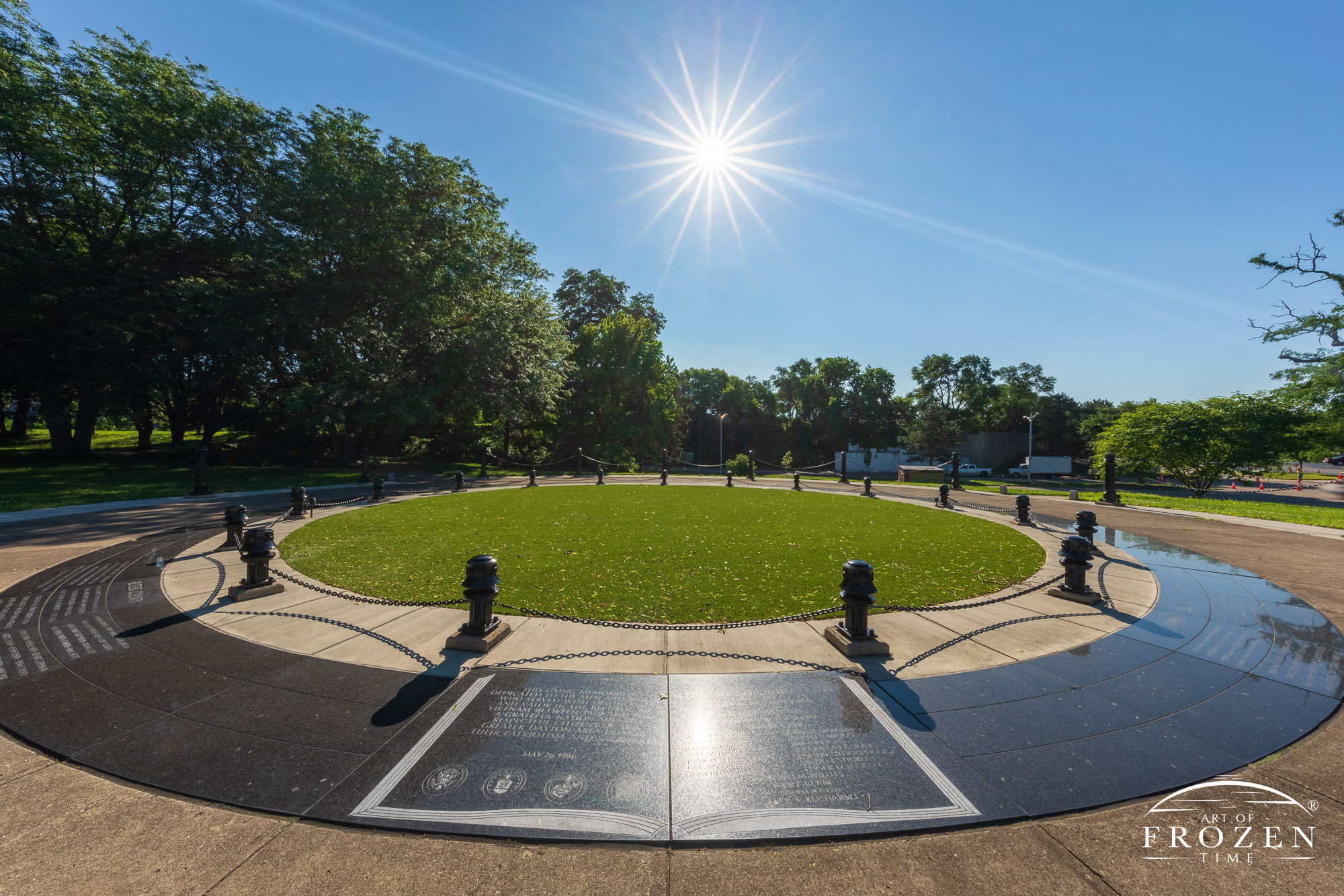 Black granite circular memorial honoring Dayton area Vietnam Veterans shines under a clear blue day in Dayton Ohio