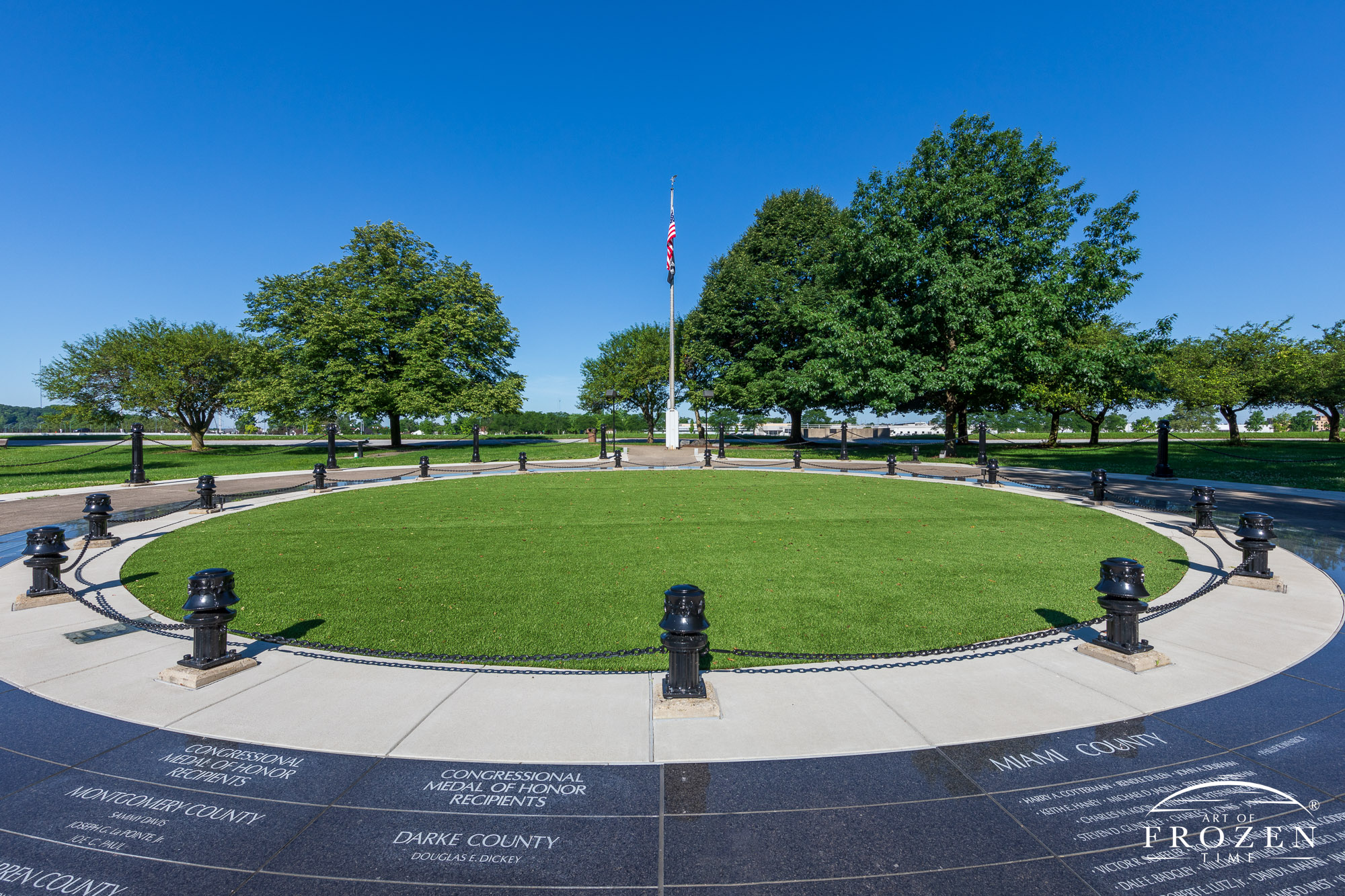 Black granite circular memorial honoring Dayton area Vietnam Veterans shines under a clear blue day in Dayton Ohio