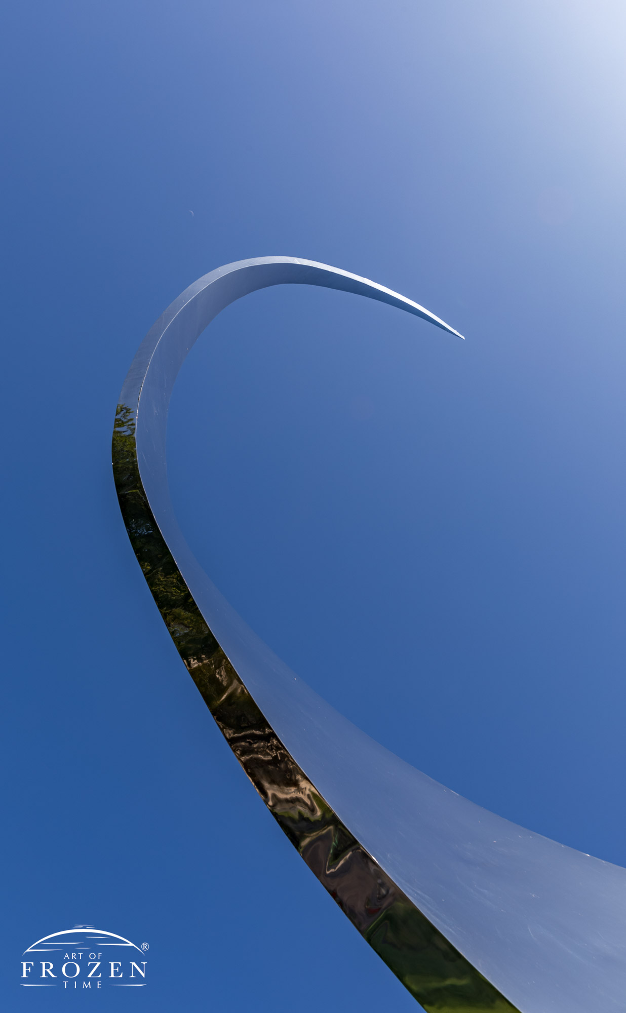 An elegant mirror-finished sculpture that spirals upward into the blue fall sky symbolizing Dayton’s role in man’s journey to space