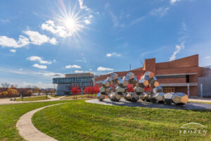 A fall scene at Wright State University where a stainless-steel sculpture consisting of many dodecahedrons mimic the DNA strands studied in the surrounding campus labs