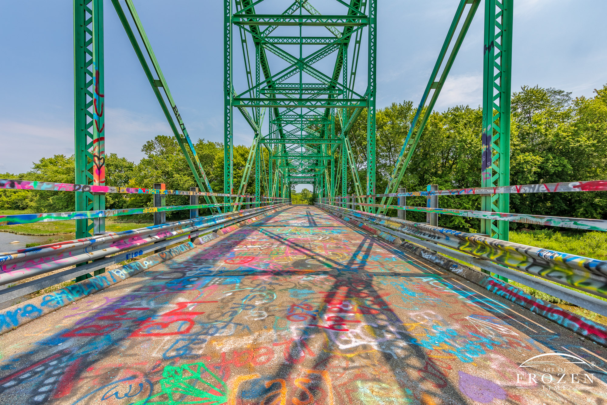 An abandoned Steel-truss bridge that now serves as a place for positive graffiti
