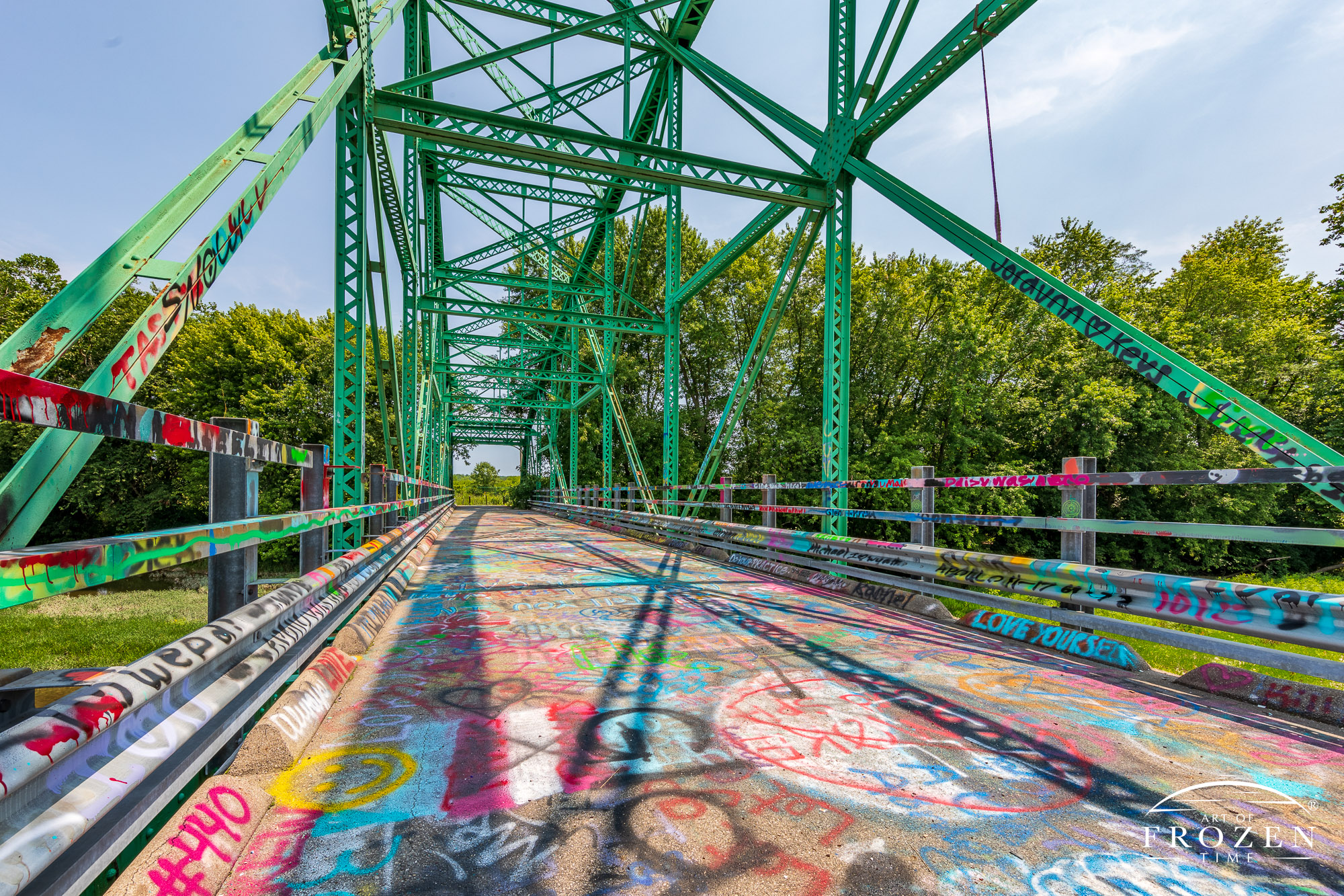 An abandoned Steel-truss bridge that now serves as a place for positive graffiti