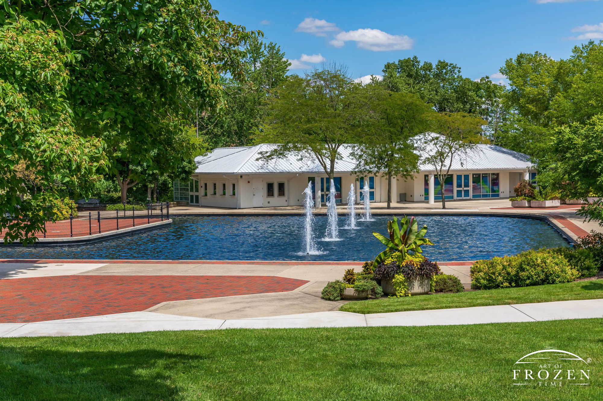 A peaceful park scene where the Fraze Pavilion Fountains dance under blue skies while filling the park with soothing sounds of splashing water