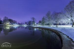 Trees around the waterscape at Kettering’s Lincoln Park Commons become snow laden following unusual spring weather