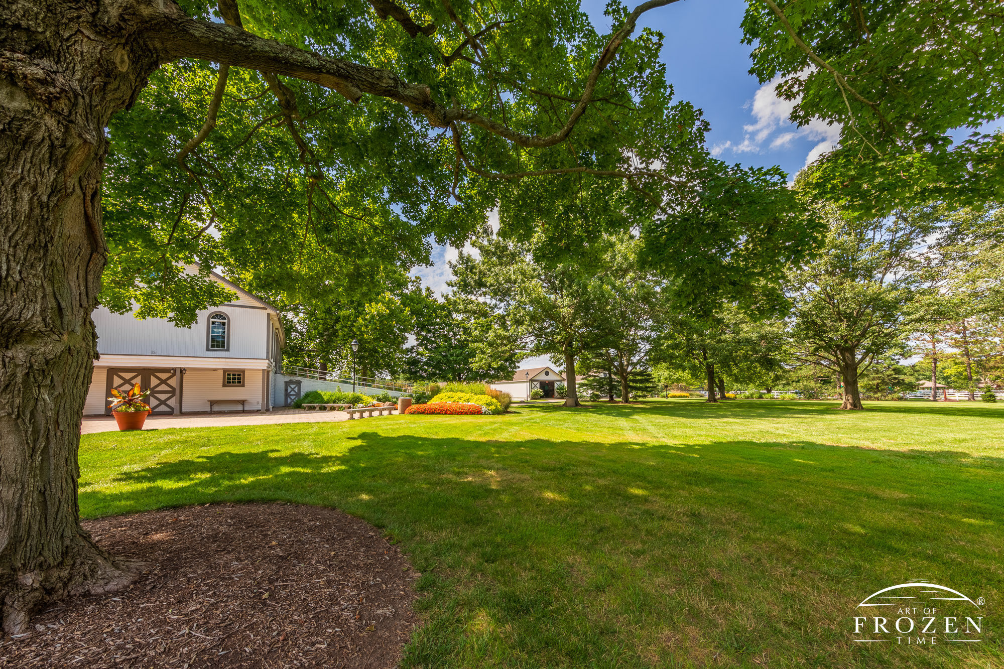 The long driveway to Polen Farm in Kettering Ohio leads the viewer towards the historic farmhouse on a sunny day